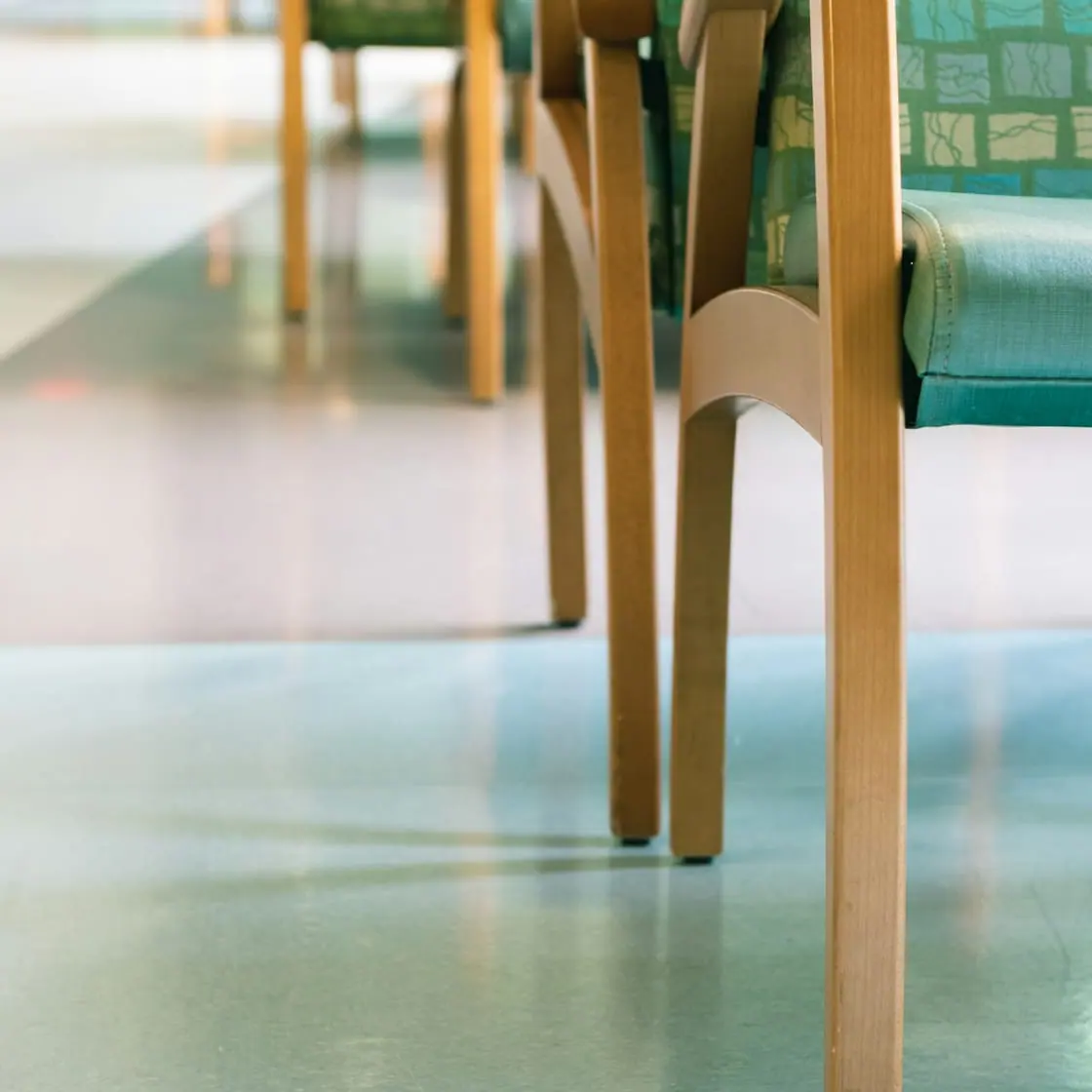 Una fila de sillas de madera vacías en la sala de espera de un centro de salud.